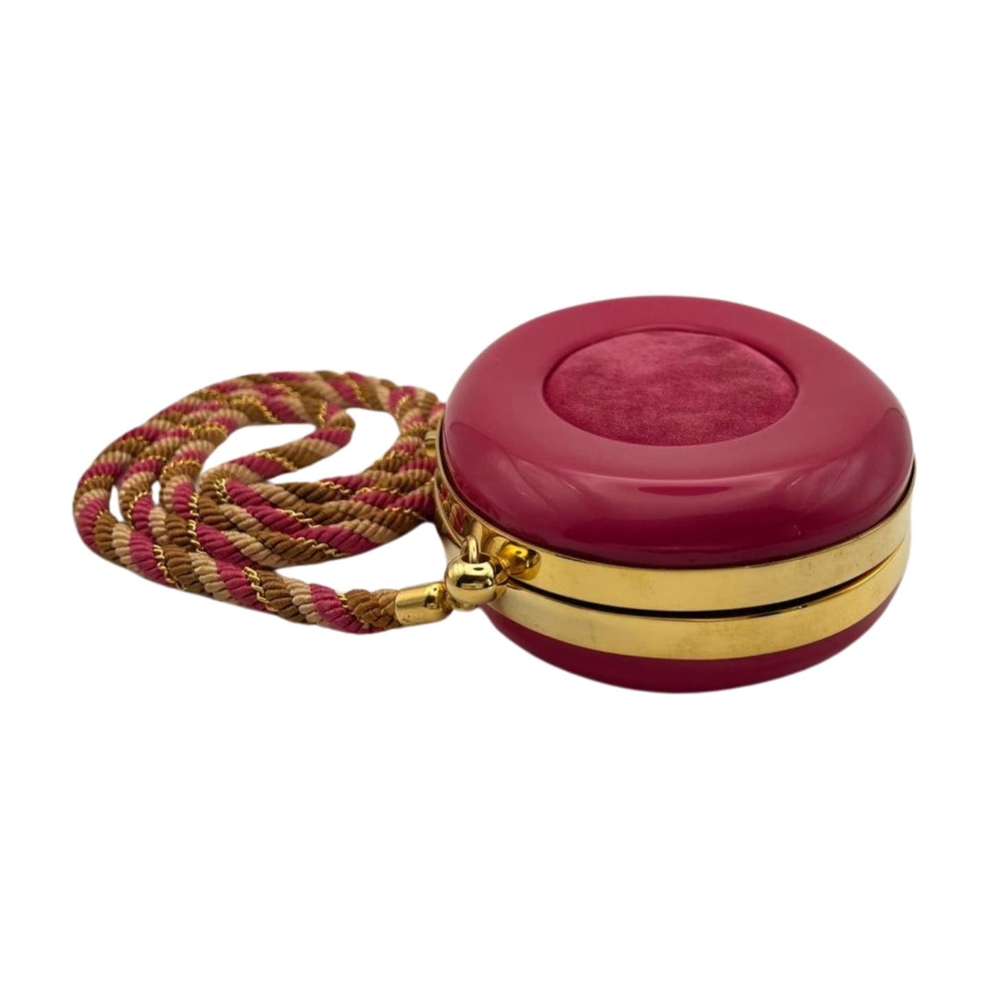 A round, deep pink handbag with gold accents and a matching braided strap. This Vintage Celine Hard Shell Bag boasts an acrylic and suede exterior, featuring a plush pink center on the lid and shiny gold trim around the opening.
